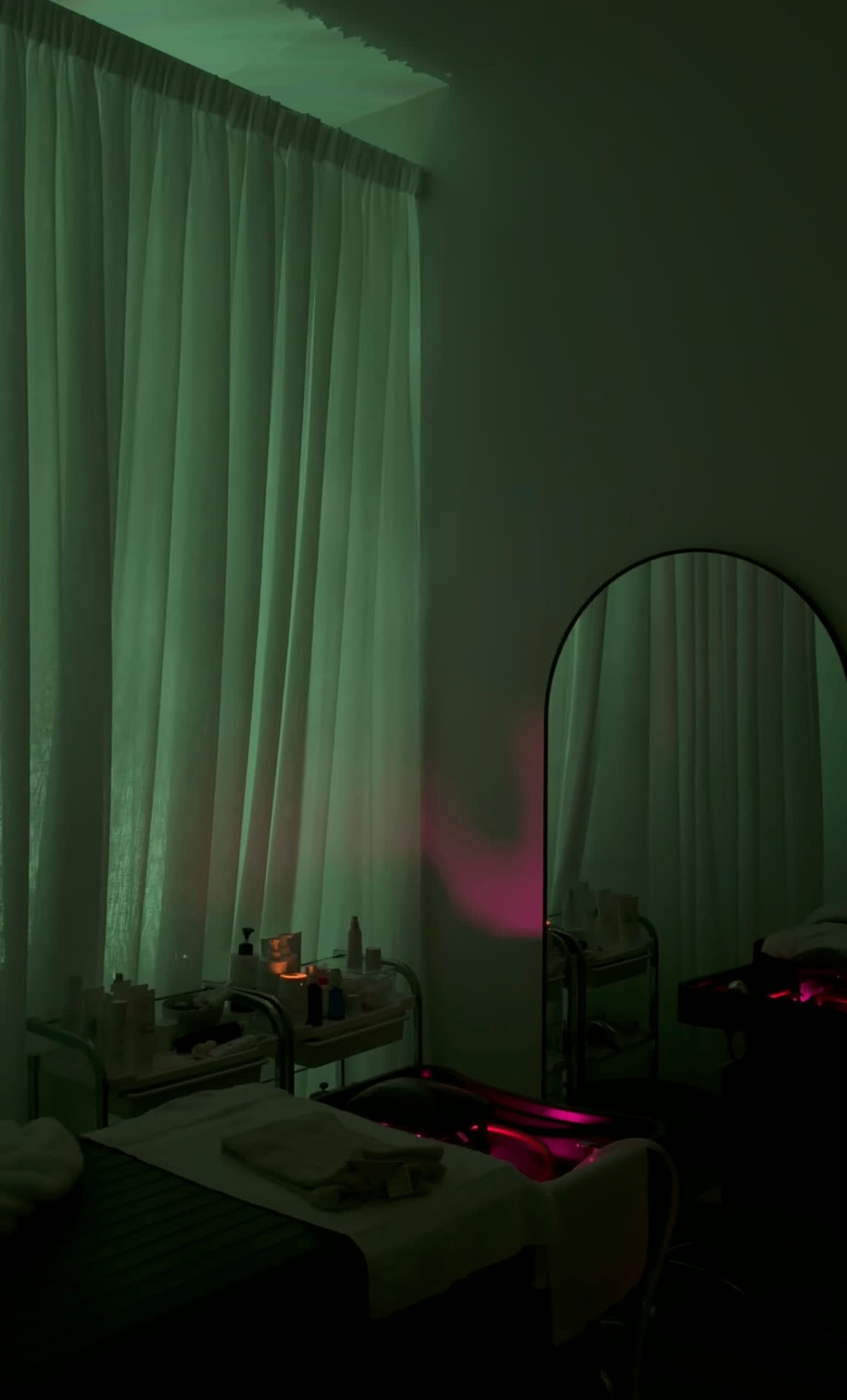 Treatment room with arched mirror at Kythara Collective